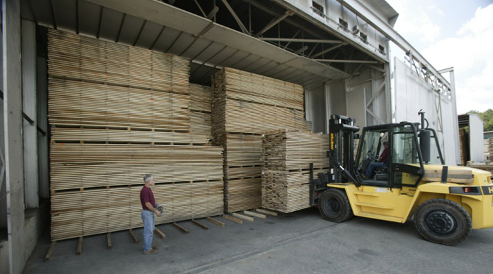Loading boards into drying kiln at J Gibson McIlvain